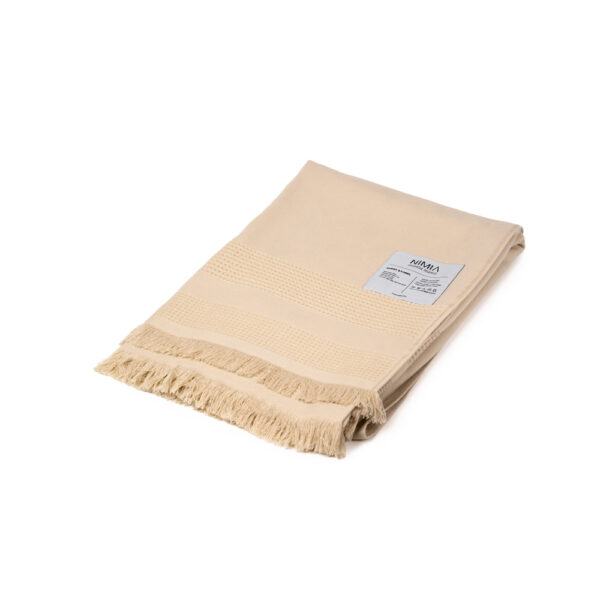 Wide towel made of soft cotton spunga with beige bangs