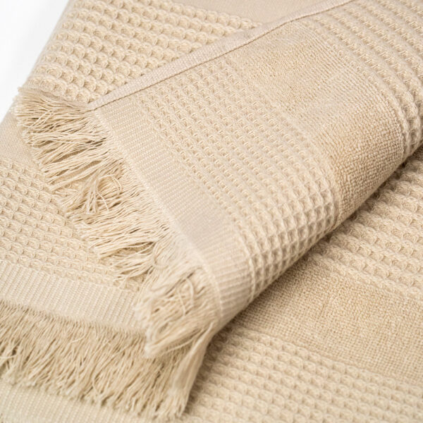 Wide towel made of soft cotton spunga with beige bangs