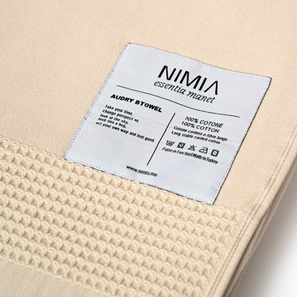 Wide towel made of soft cotton spunga with beige bangs